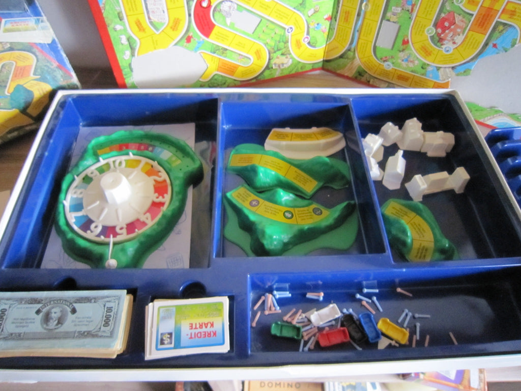 Spiel des Lebens – Glücksrad, Landschaftsteile, Gebäude, Spielgeld, Karten und Figuren